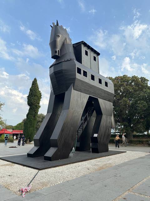      Reconstructed wooden Trojan Horse with people around.
  