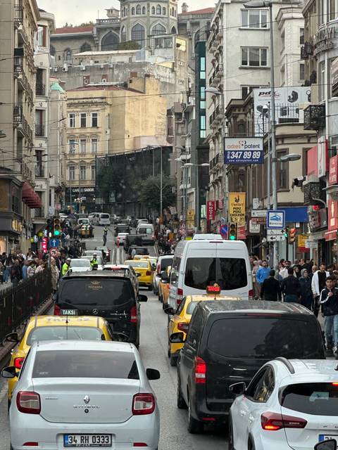       Busy city street with buildings and vehicles.
  