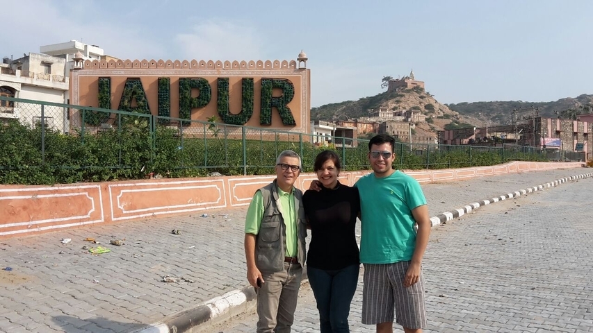       Group in front of a sign reading 'Jaipur'.
  