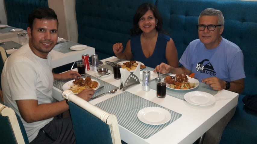       Family dining at a restaurant.
  