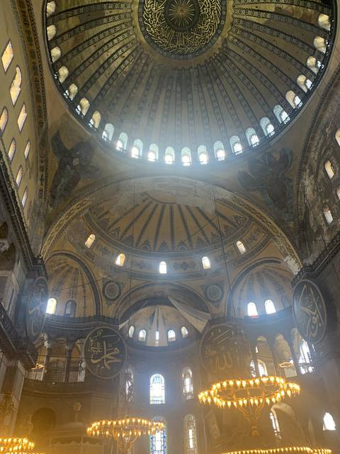       Interior of a mosque dome with intricate designs.
  