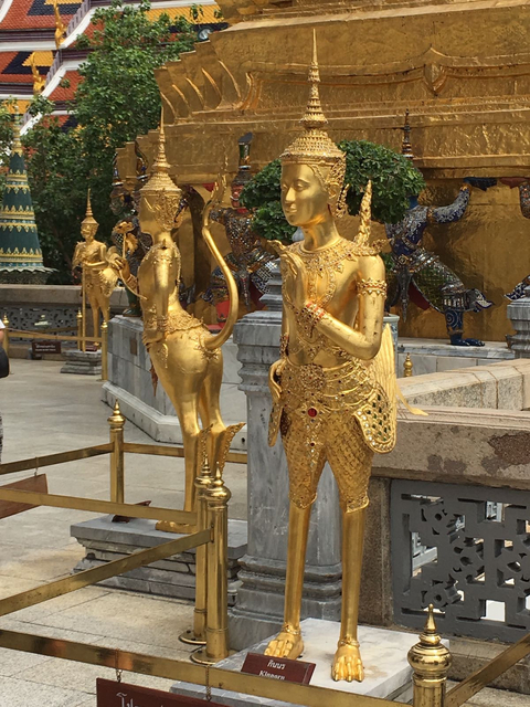 Gold statues in an ornate setting, likely a temple.
