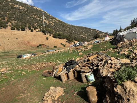 Inverted landscape with scattered debris and tents.