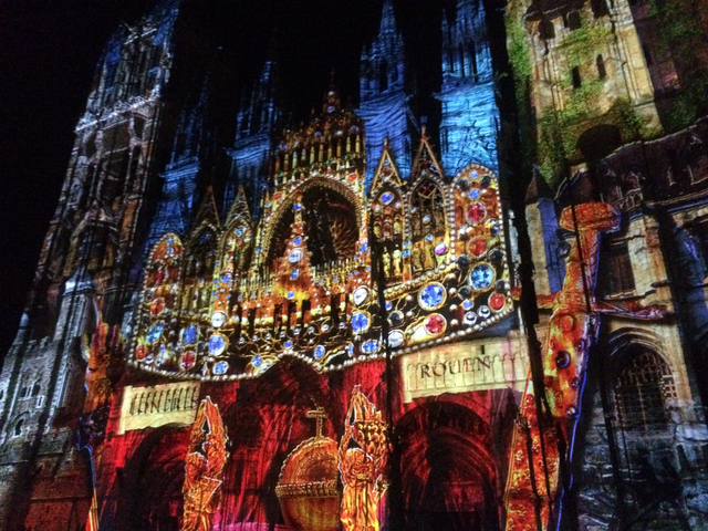 A light projection on a gothic cathedral at night.