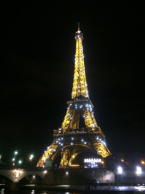 The illuminated Eiffel Tower at night.