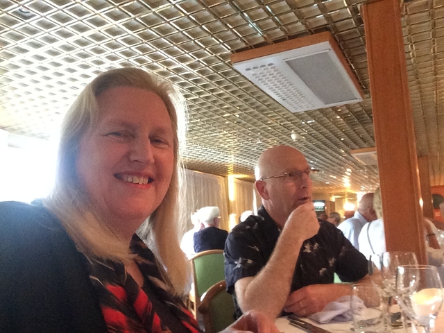 Two passengers smiling inside a cruise ship.