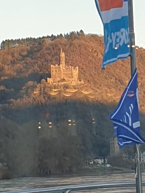       Distant castle view in a hilly landscape.
  