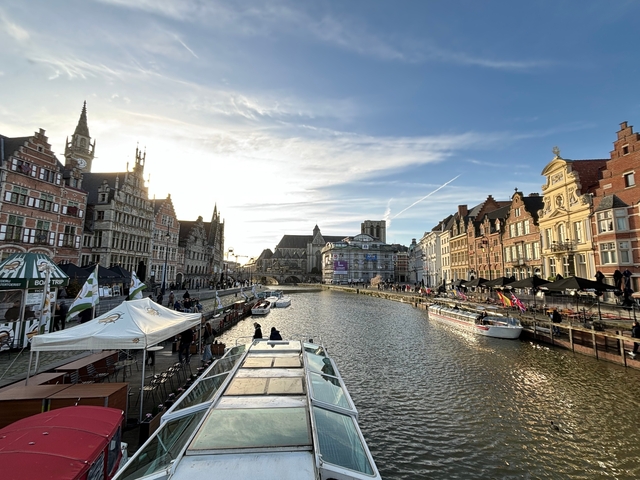 A riverside view with historic European buildings lining the banks.