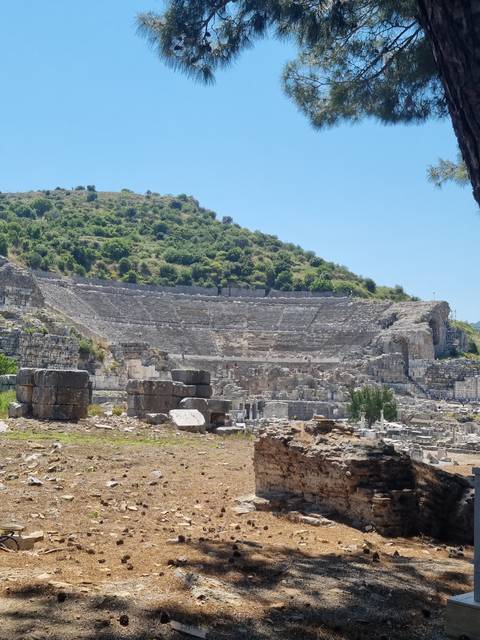 Ruins of an ancient structure on a hillside.