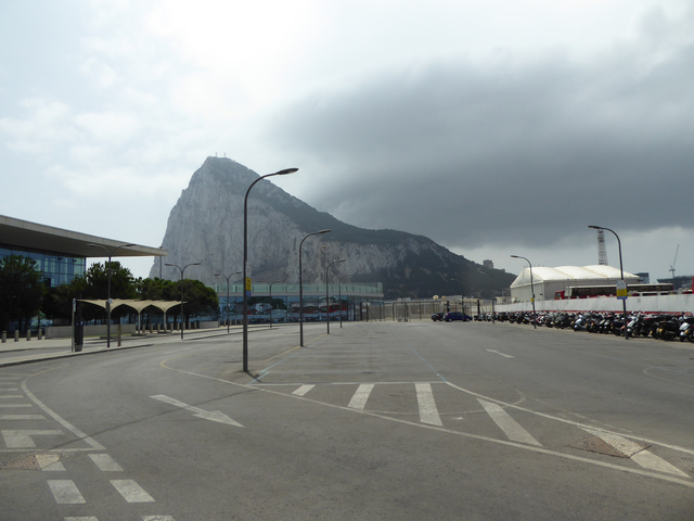 Rock of Gibraltar towering over an empty parking lot.
