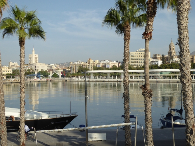 Cityscape with reflected buildings on a waterfront.