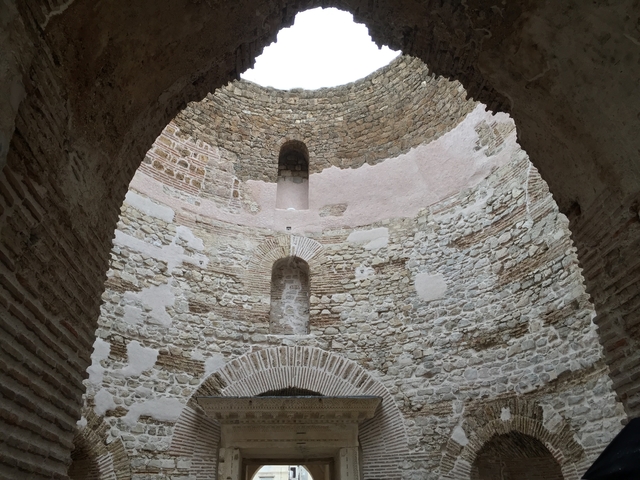       Brick interior of an ancient rotunda with arches.
  