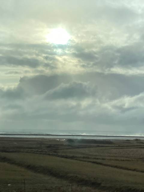       Overcast sky with a field and dateline.
  