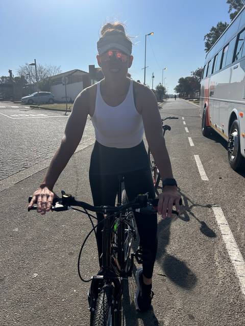       Woman riding a bicycle on a sunny day.
  