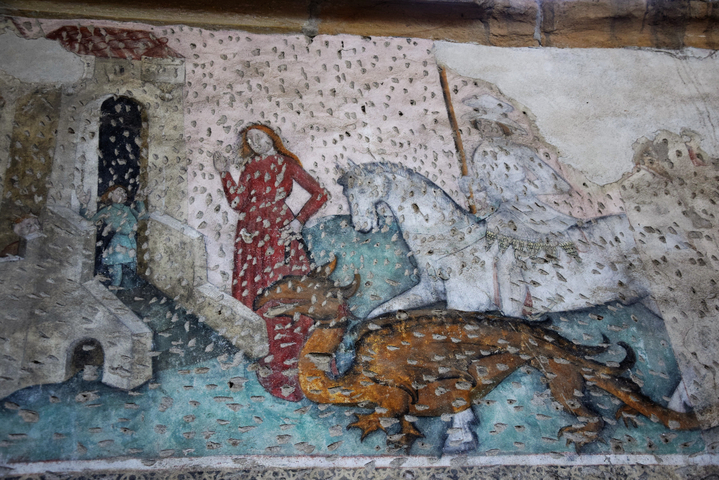 Ancient fresco depicting a scene with people and animals.