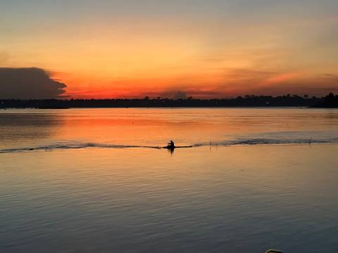       Boat at sunset on a calm sea.
  
