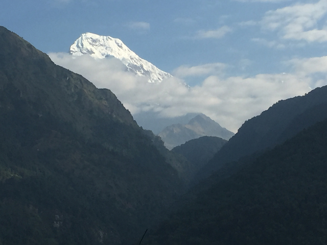 Snow-capped mountain peaks above clouds.