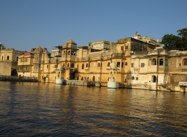       Ornate buildings by the water under a golden sunset.
  