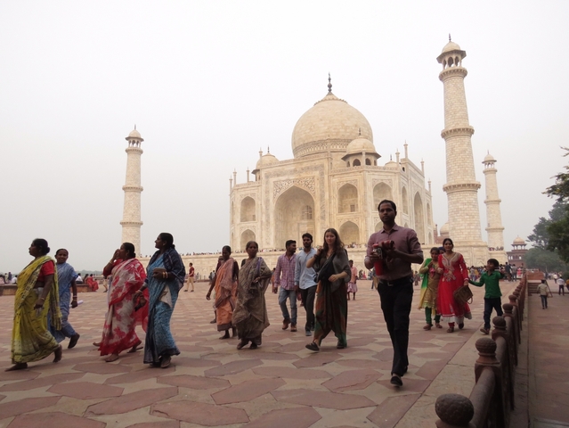       Visitors walking around the Taj Mahal.
  