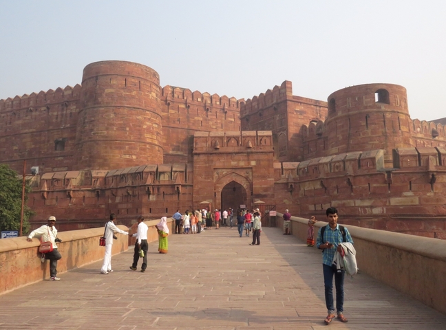       People visiting a large historic fort.
  
