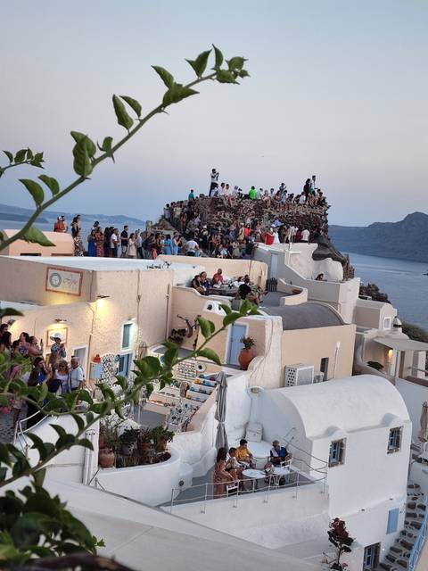       Crowded terrace with people enjoying the view.
  