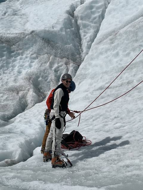       Climbers with gear on icy terrain.
  