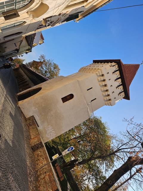 A white tower in an urban setting.