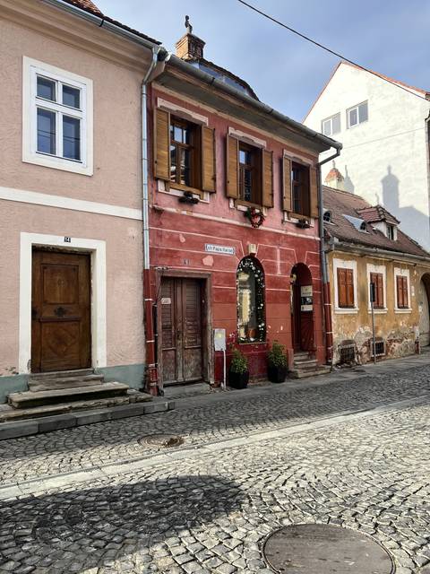 Colorful historic buildings on a cobblestone street.