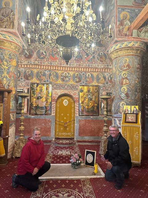 Interior of a decorated room with two people sitting.