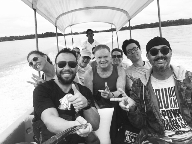 Group of people on a boat ride posing for a photo.