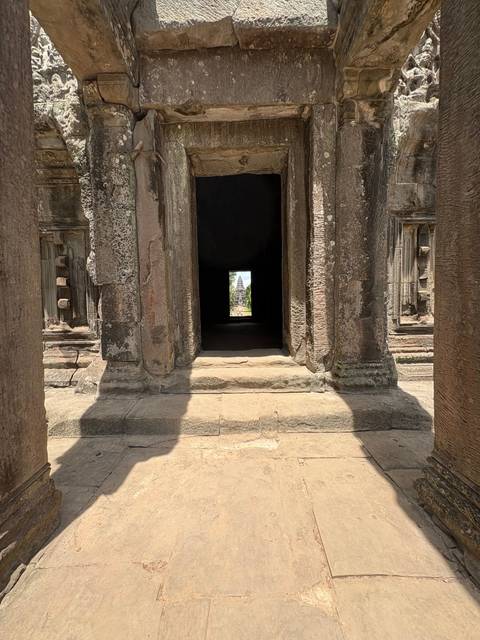 A stone window frame offering a view through the ruins.