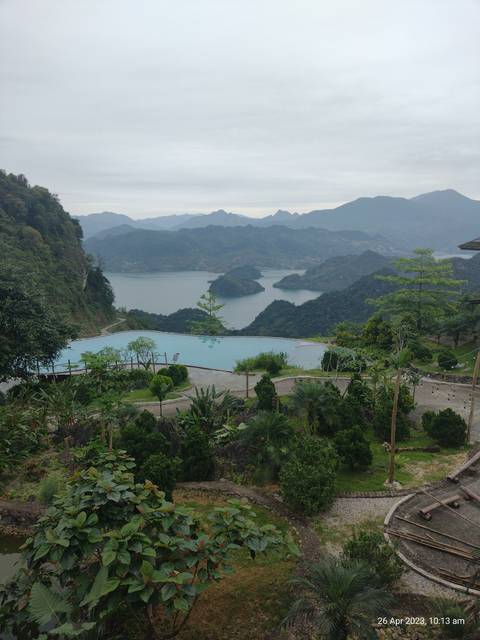       Mountainous landscape with a body of water, photo is rotated.
  