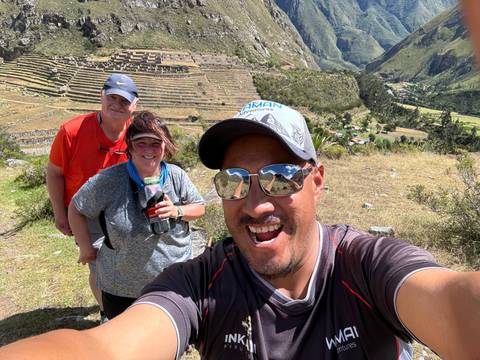 Two people taking a selfie with scenic background.
