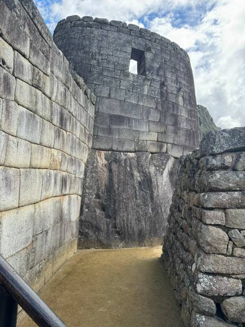 Inca stone structures with blue sky.