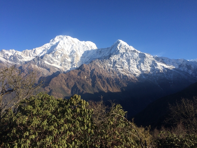 Majestic snow-capped mountains with clear blue sky.