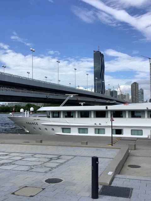 Image of modern architecture with a bridge in the background.