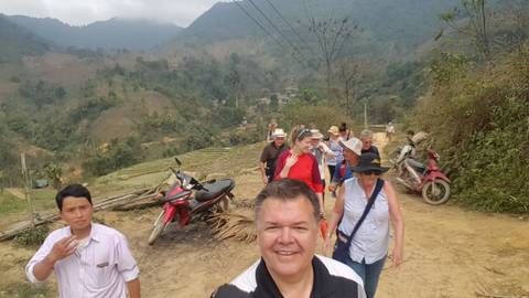       Group touring a rural area with views of fields.
  