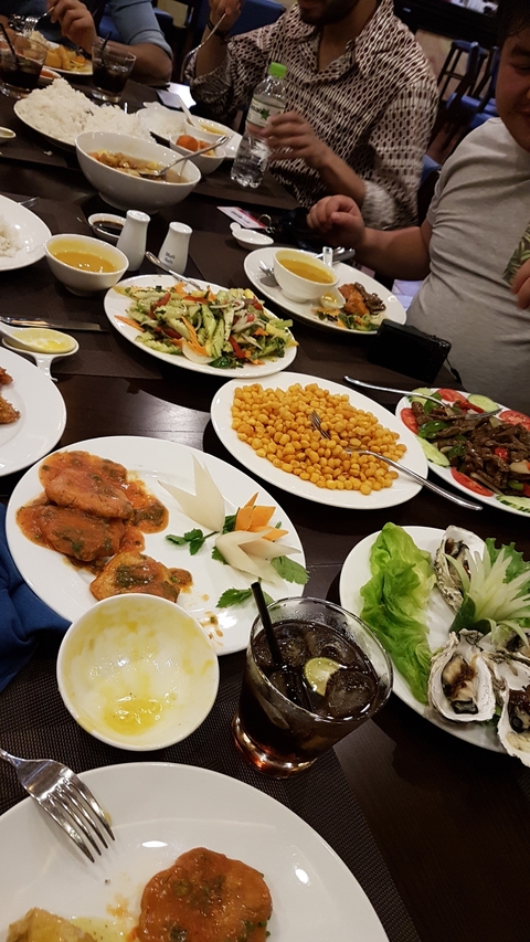 Dinner table with various Asian dishes.