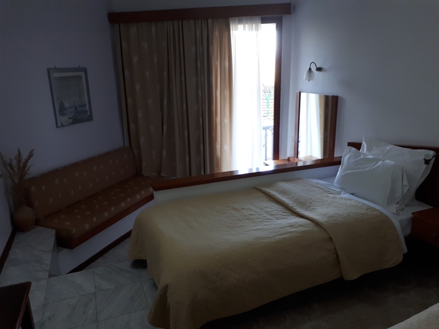 Simple room interior with a bed and a window.