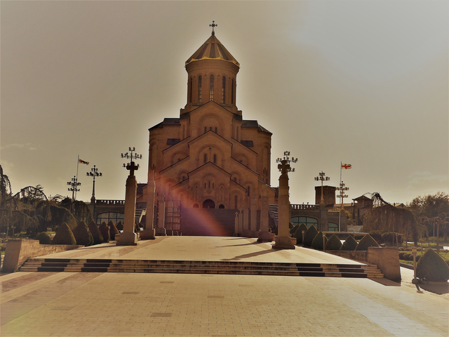 Historic cathedral with sunflare, viewed from the front.