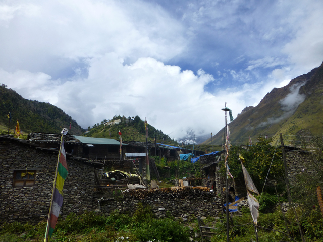 Traditional village against a mountainous backdrop.