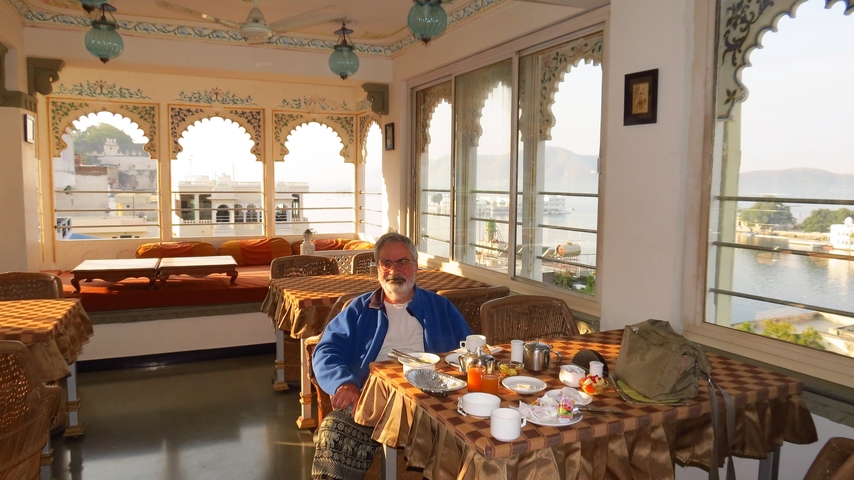       A person dining with a scenic city view from a restaurant.
  
