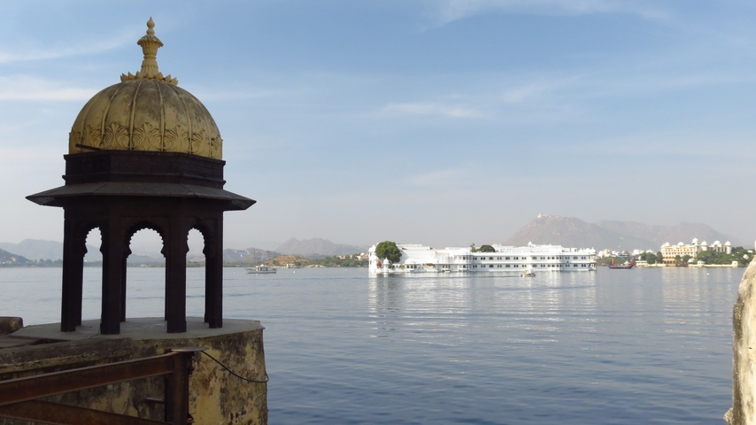       A view of a lake with a floating hotel in the distance.
  