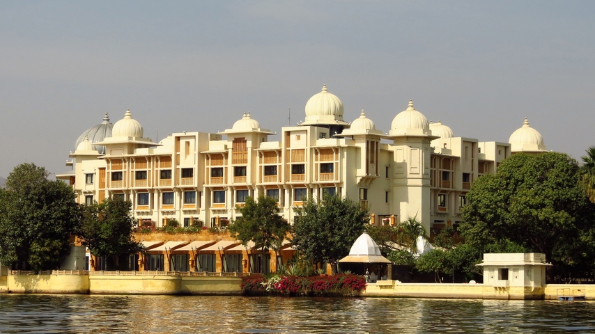       A hotel building by the lake reflecting royal architecture style.
  