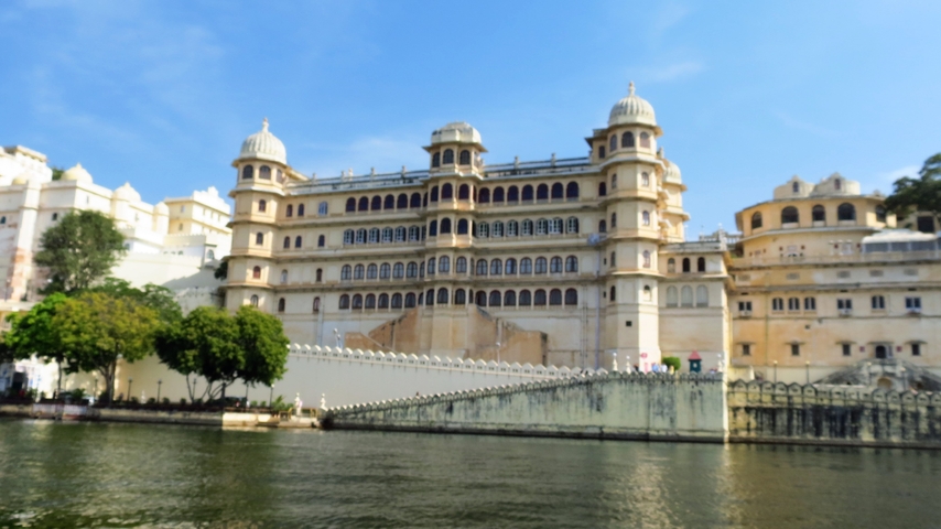 A historic building by a waterfront, appearing slightly blurry.