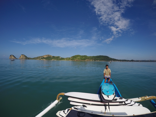 Clear blue waters with islands in the distance.