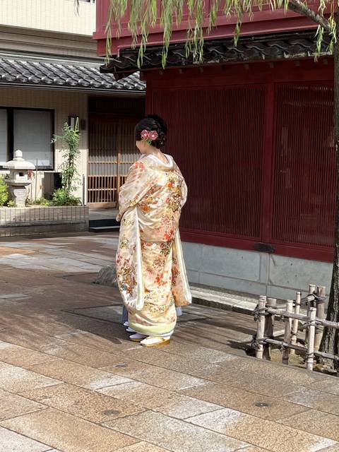       A person in a traditional kimono walking along a street.
  
