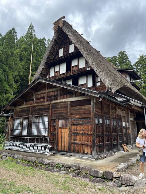 Traditional wooden building with thatched roof.