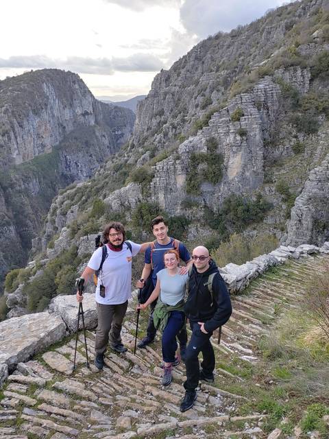       Group of hikers posing on a mountain path.
  