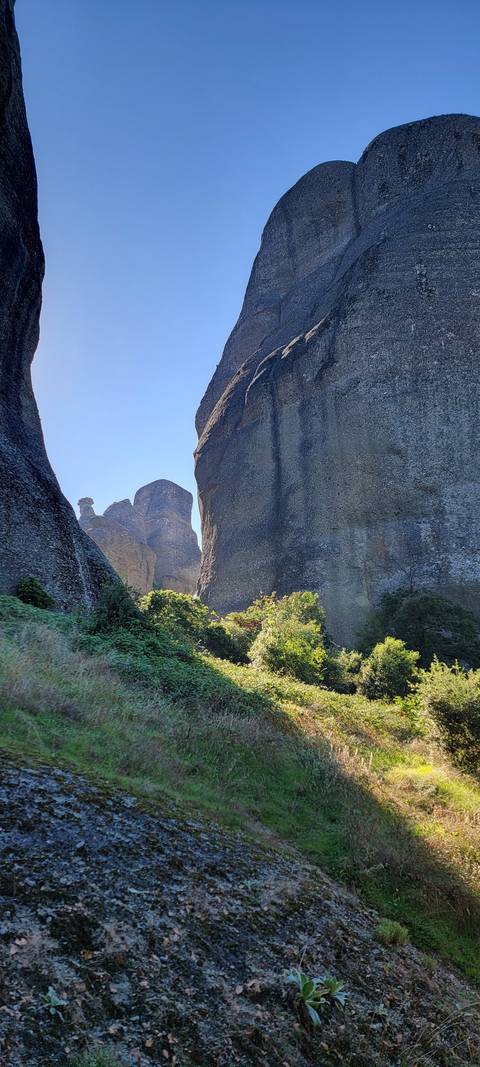 Tall rock formations against the clear blue sky.